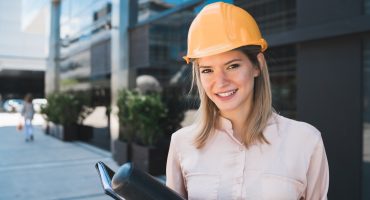 Professional architect woman standing outdoors.