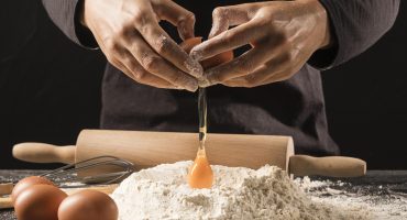 close-up-chef-pouring-egg-flour