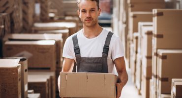 Young man working at a warehouse with boxes