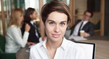 Smiling female worker posing for company business catalogue