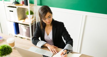 Concentrated woman preparing to teach her online class